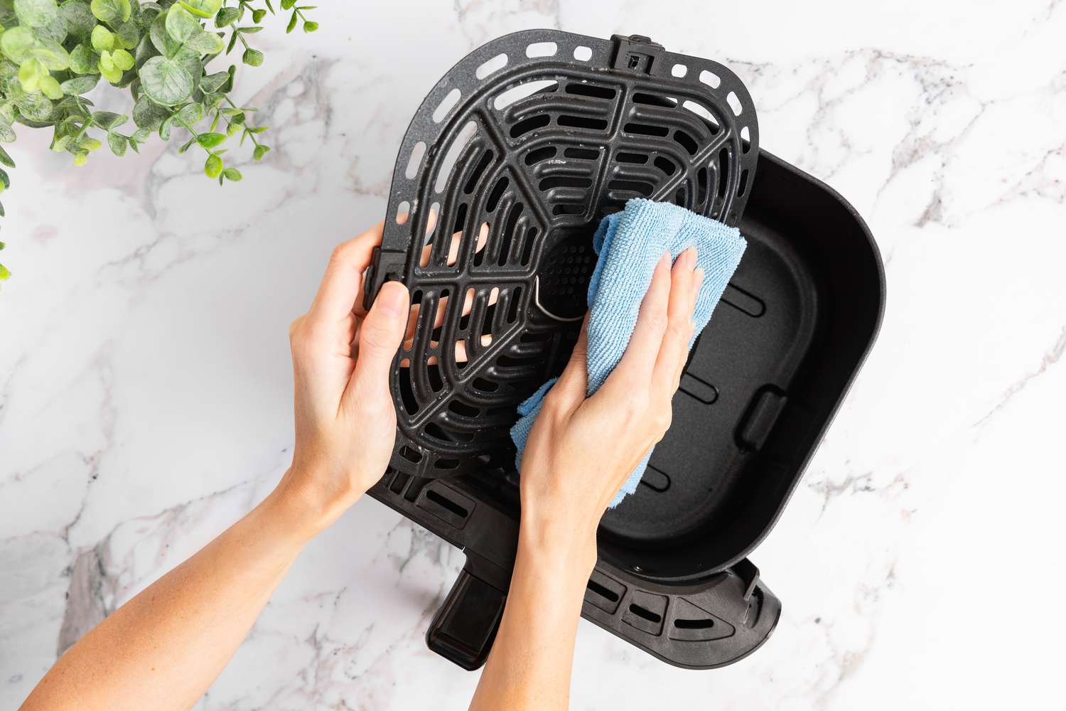 Soaking air fryer tray in water for cleaning