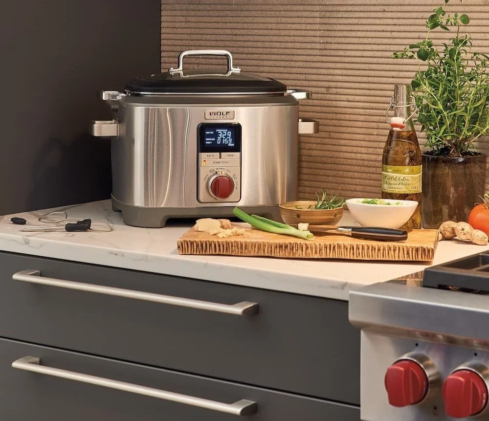 Stainless steel multi-function slow cooker appliance with digital display on countertop