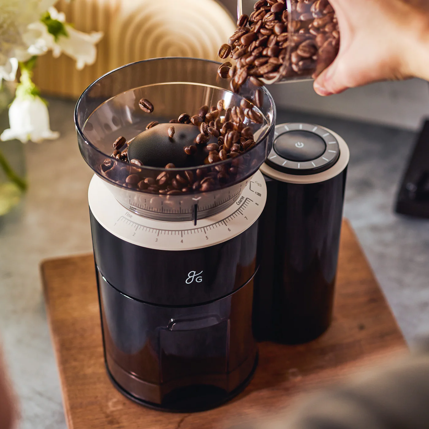 Electric conical burr grinder on a modern kitchen counter