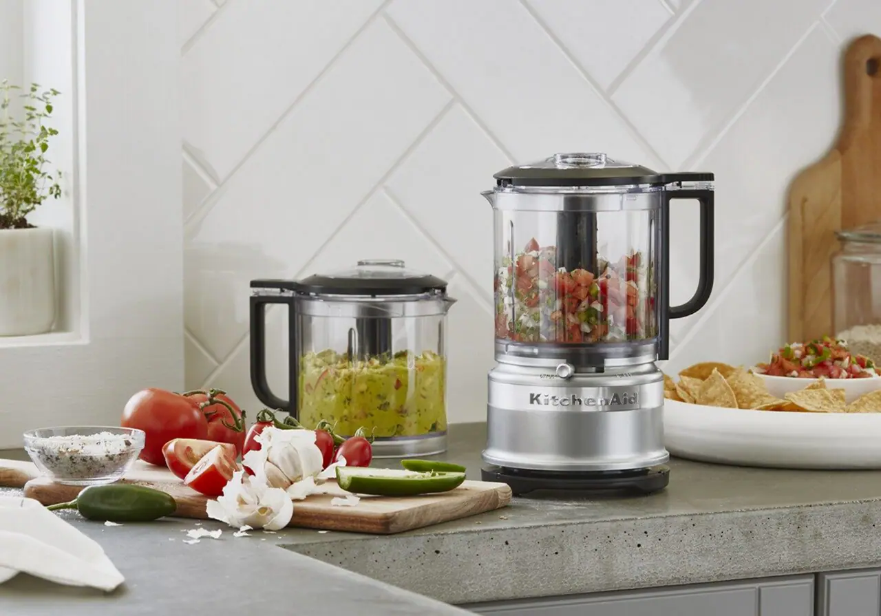 Food processor blending fresh vegetables for family dinner