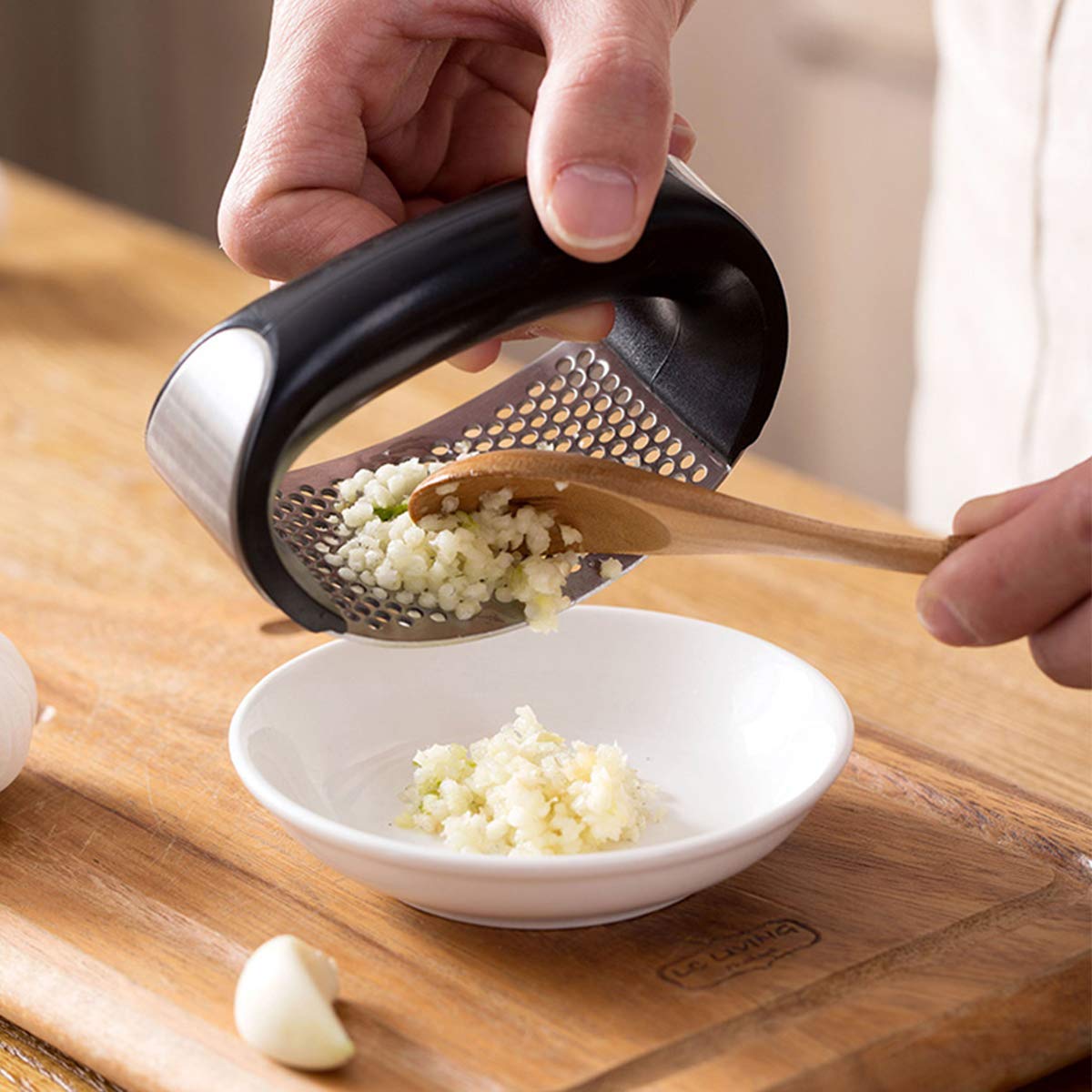 using a garlic press to mince garlic quickly for faster everyday meal prep