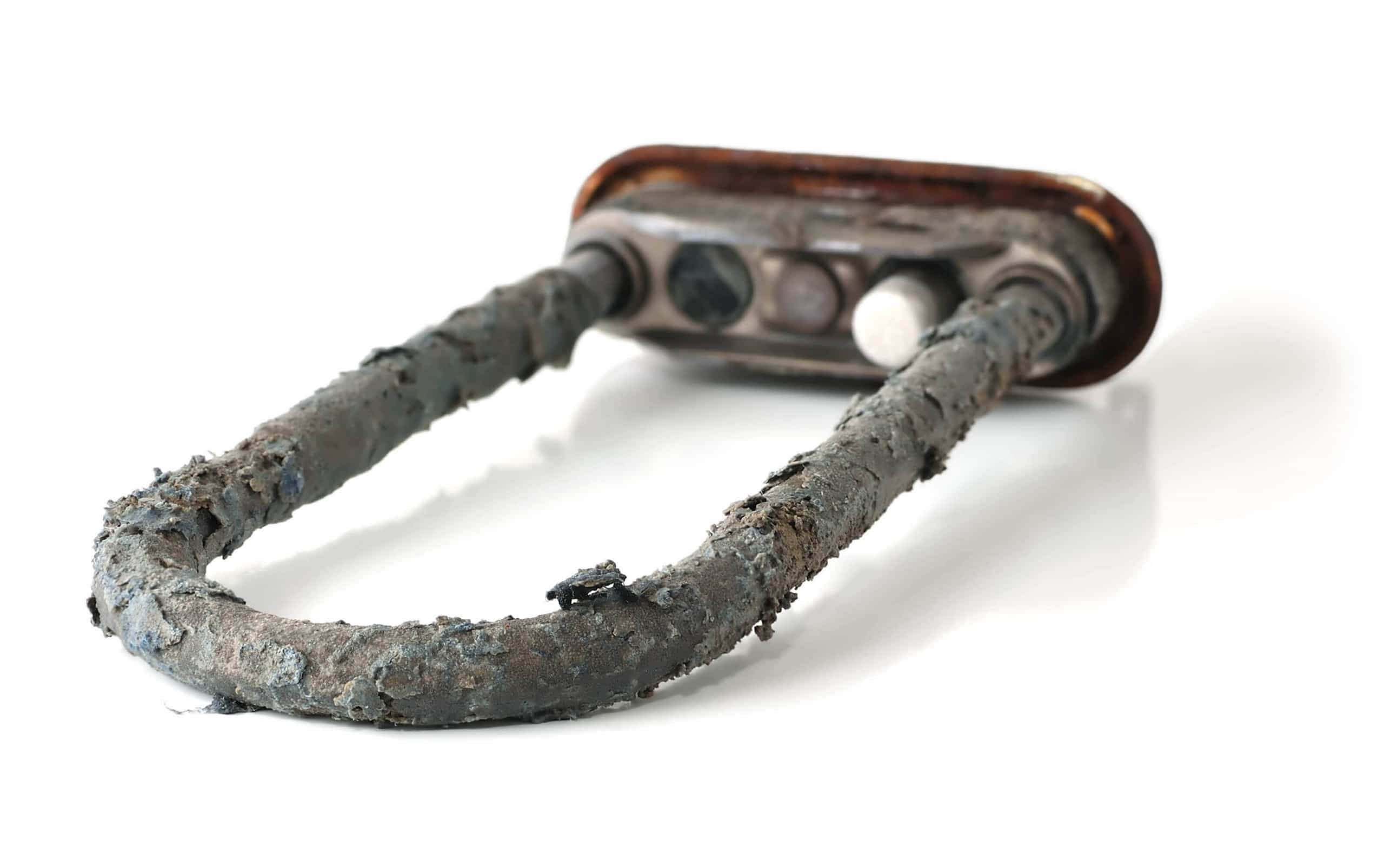 Limescale buildup inside a coffee machine restricting water flow over time