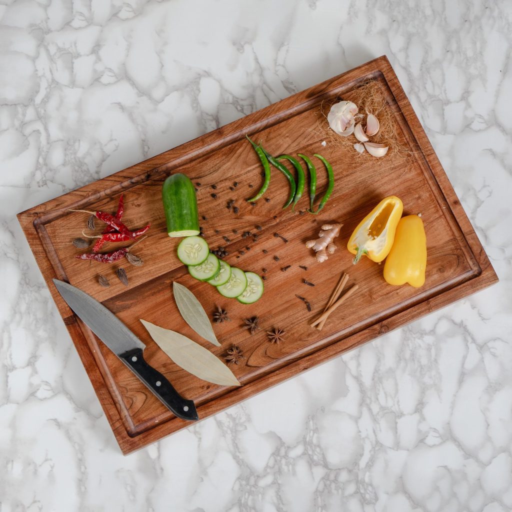 kitchen tools and fresh vegetables arranged on a cutting board for faster meal prep