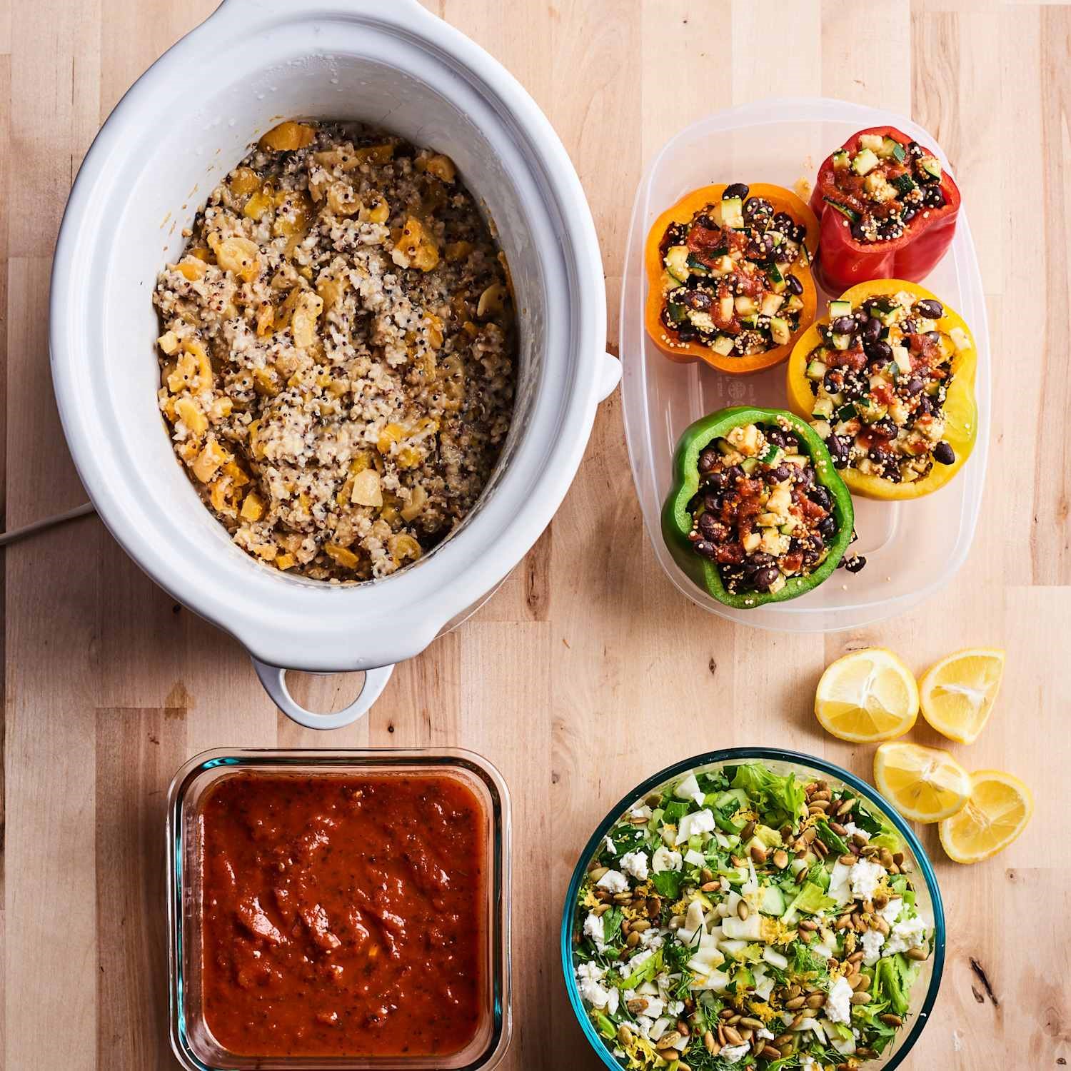 slow cooker meal prep with stuffed peppers, grains, and fresh ingredients organized for the week