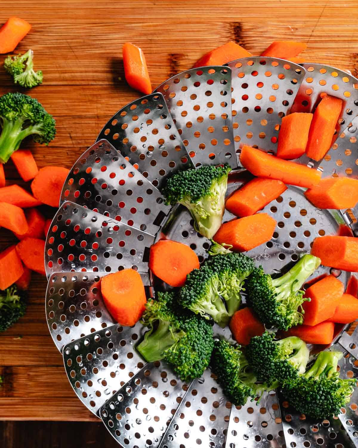 Steamed broccoli and carrots prepared in a stainless steel food steamer for healthy cooking