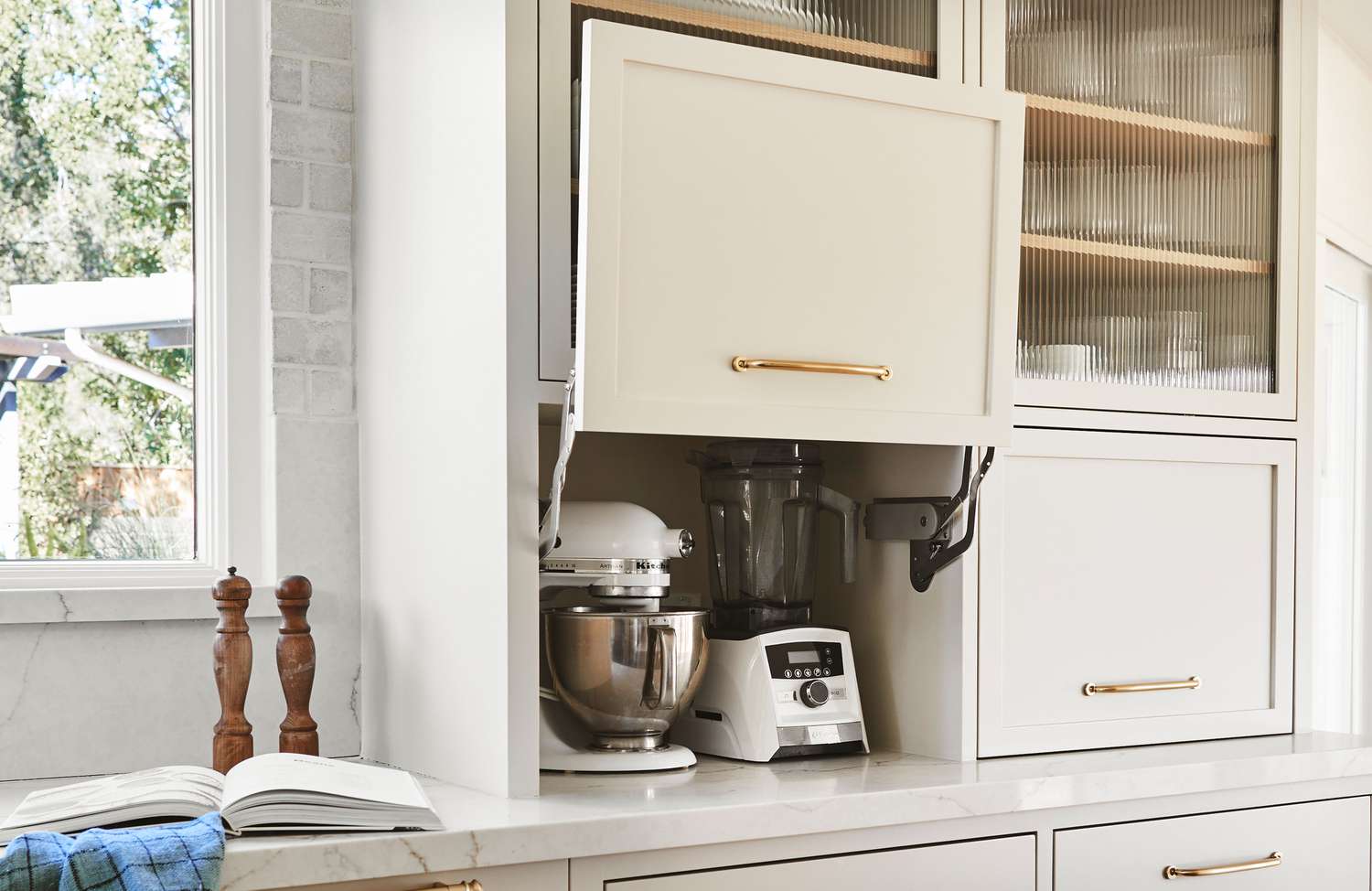 Blender stored inside a closed kitchen cabinet with limited ventilation around the motor base
