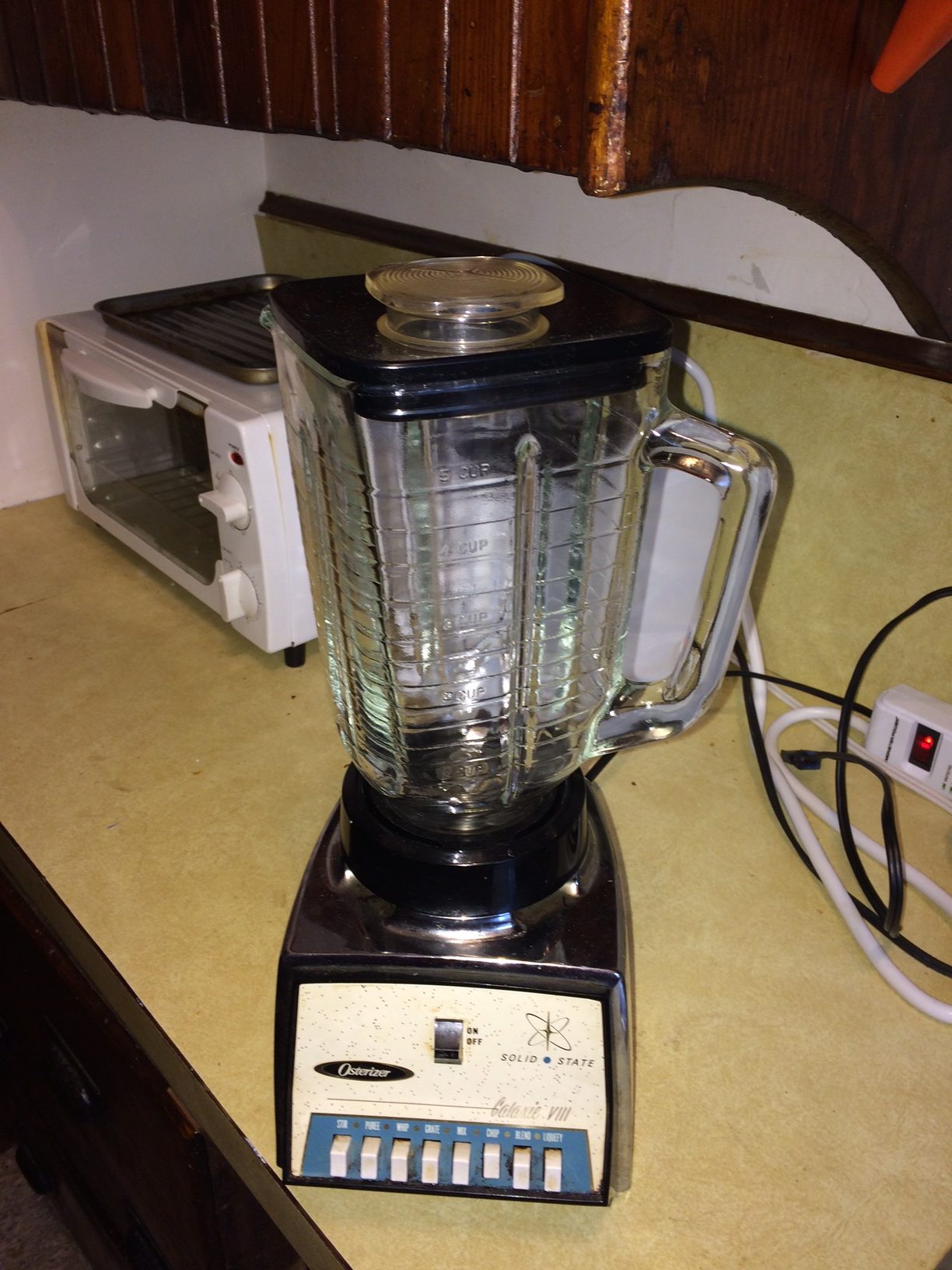 Old vintage blender with worn controls and aging motor base on kitchen counter