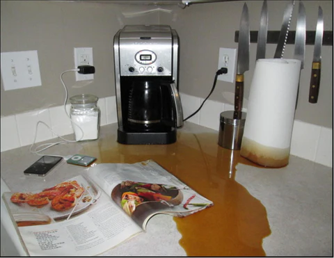 Dirty coffee maker with residue buildup contributing to slow brewing