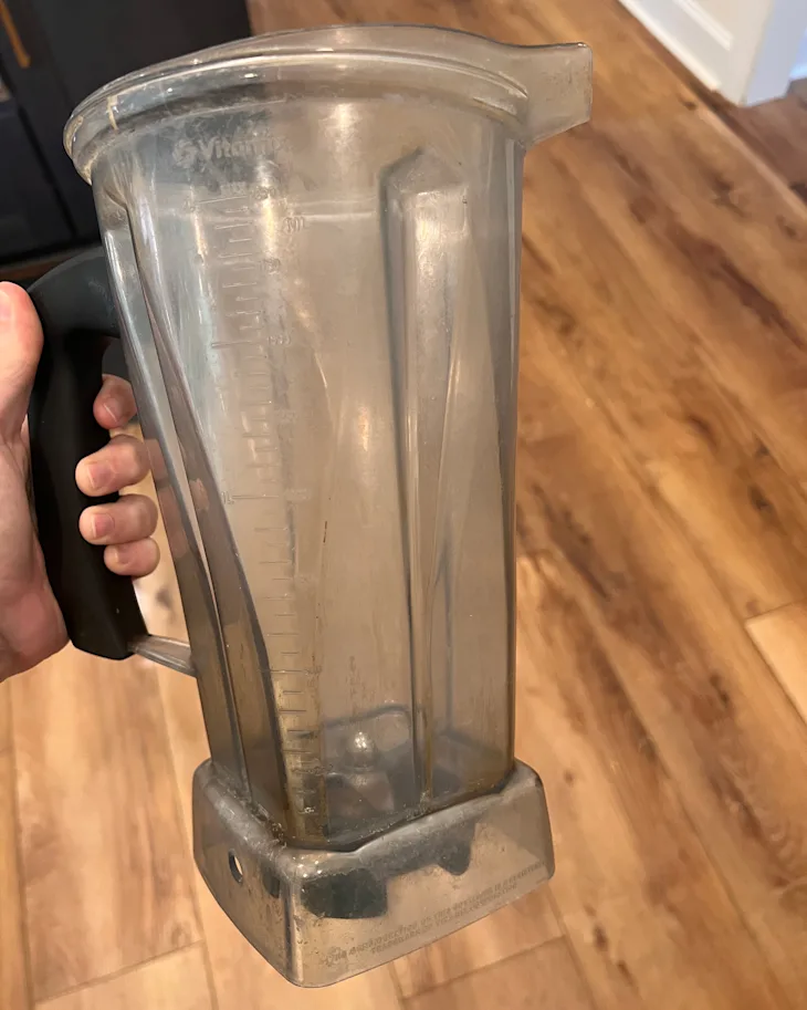 Cloudy blender jar with residue buildup around the blade assembly area